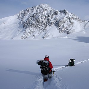Hikers approaching a snowy peak